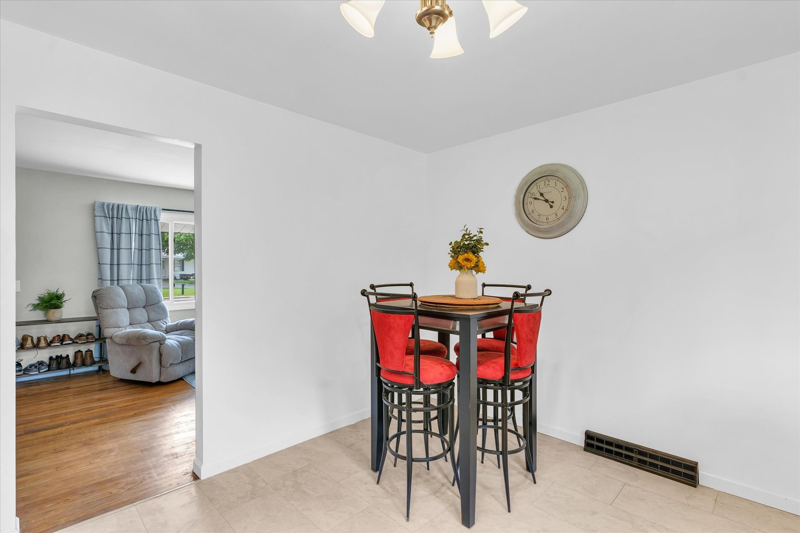 1617 Cornell Drive Champaign, IL 61821 - Photo 12 of 31 a view of dining room and livingroom with furniture wooden floor a rug and a clock