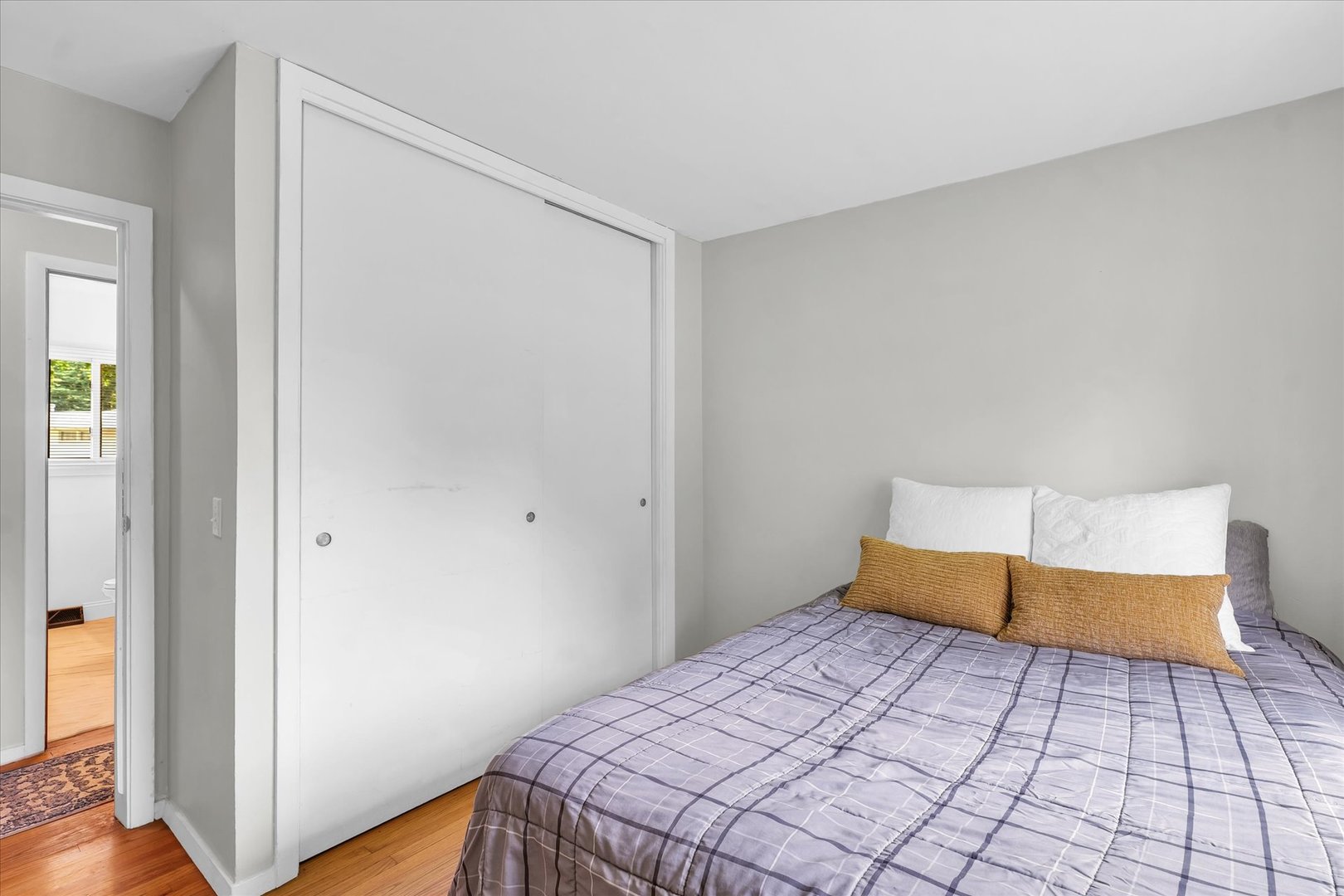 1617 Cornell Drive Champaign, IL 61821 - Photo 19 of 31 a bedroom with a bed and wooden floor