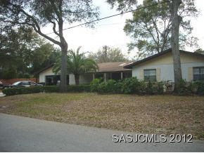 180 Hawthorne Road St. Augustine, FL 32086 - Photo 1 of 7 a front view of a house with a garden