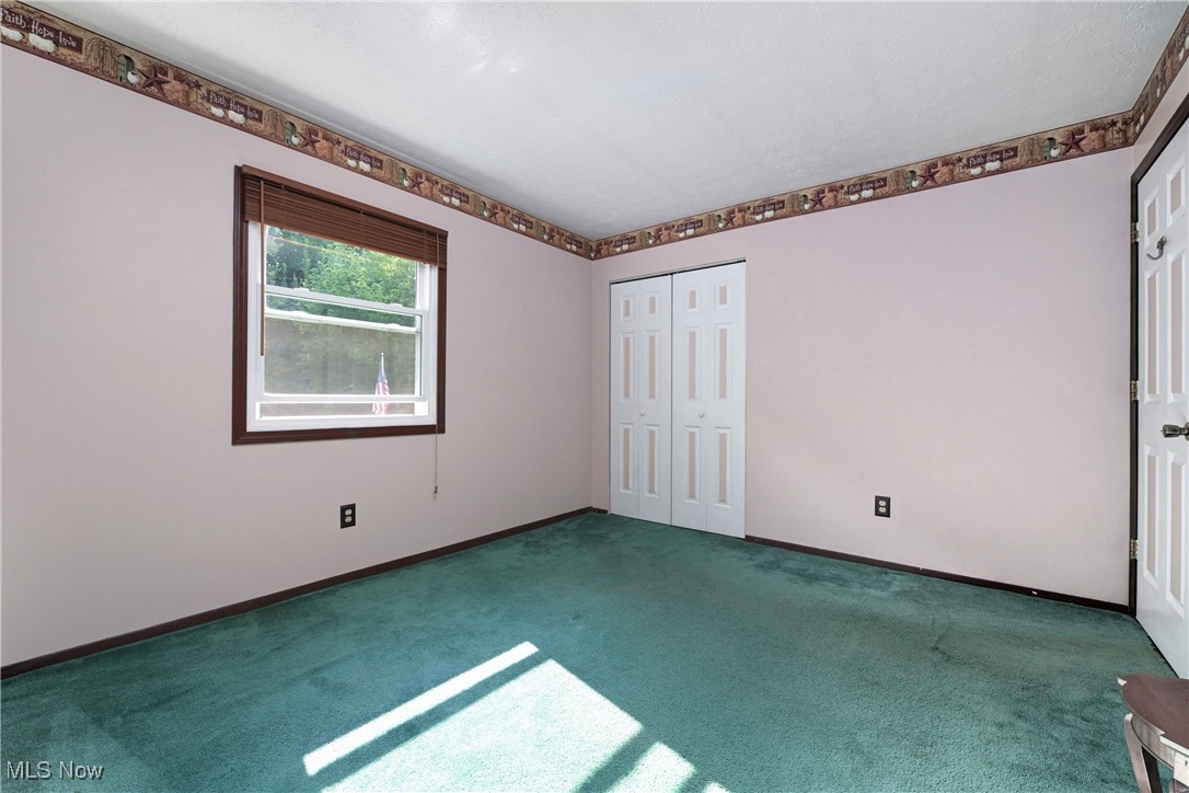 1820 Claus Road Vermilion, OH 44089 - Photo 8 of 10 Unfurnished bedroom with carpet and a closet