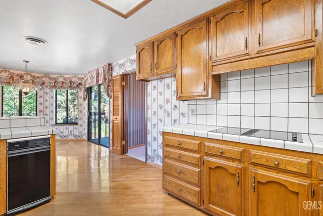 a kitchen with granite countertop cabinets and wooden floor