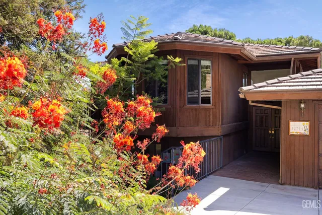 a living room with furniture and large windows