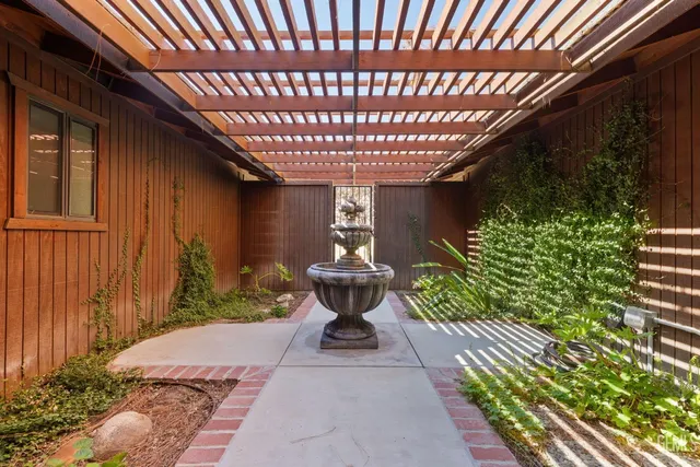 a living room with furniture and a kitchen