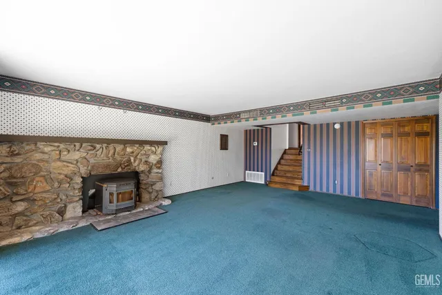 a bathroom with a granite countertop sink and a large mirror