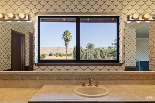 a view of a big house with a big yard and large trees