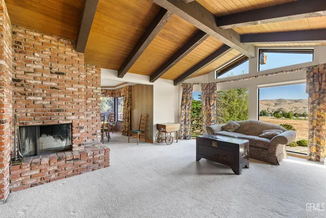 a living room with furniture and a ceiling fan