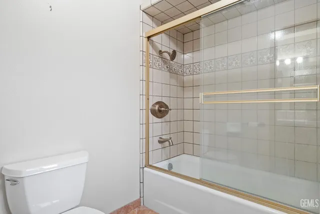 an aerial view of a house with yard and mountain view in back