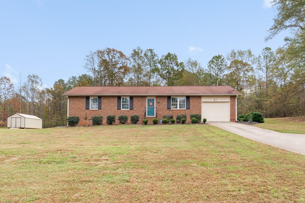 87 Girl Scout Road Newnan, GA 30263 - Photo 1 of 1 a front view of a house with a yard and garage