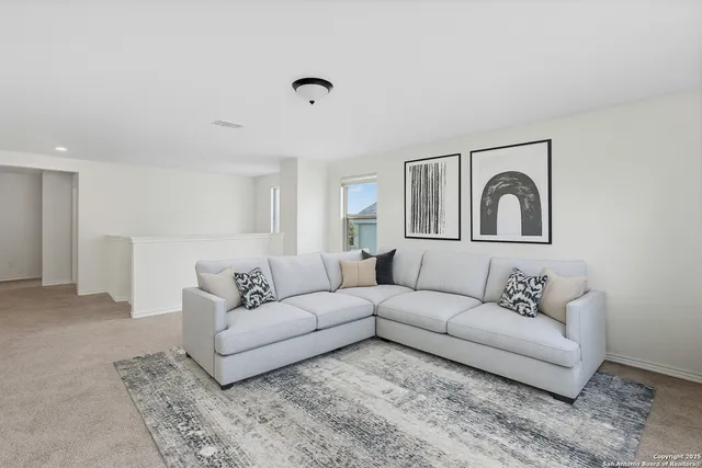 a living room with furniture and a mirror
