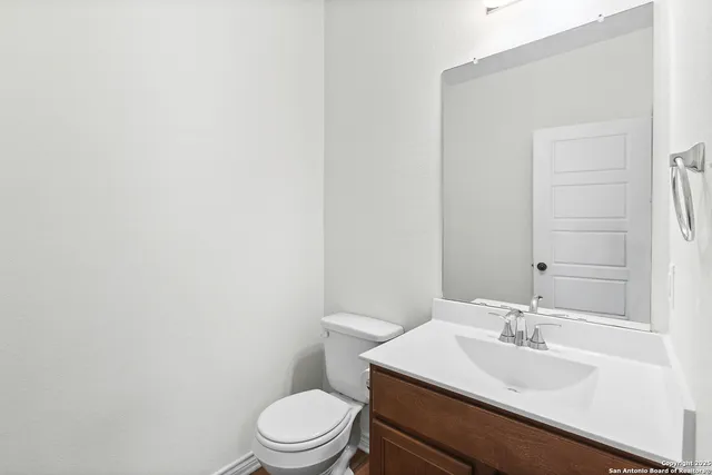 a bathroom with a sink a toilet and mirror