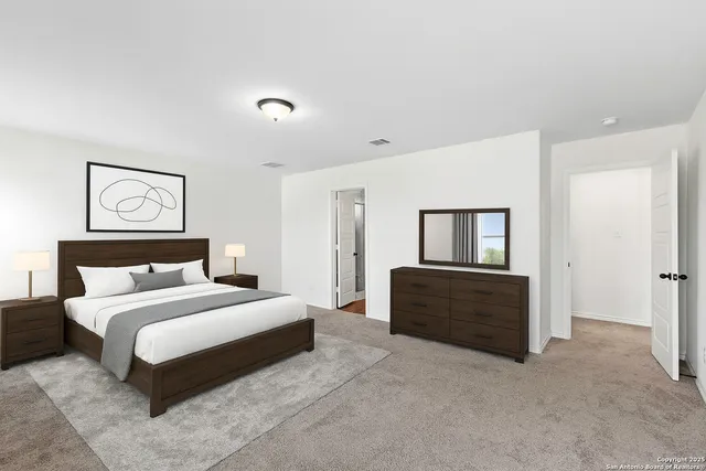 a bedroom with a bed and cabinet