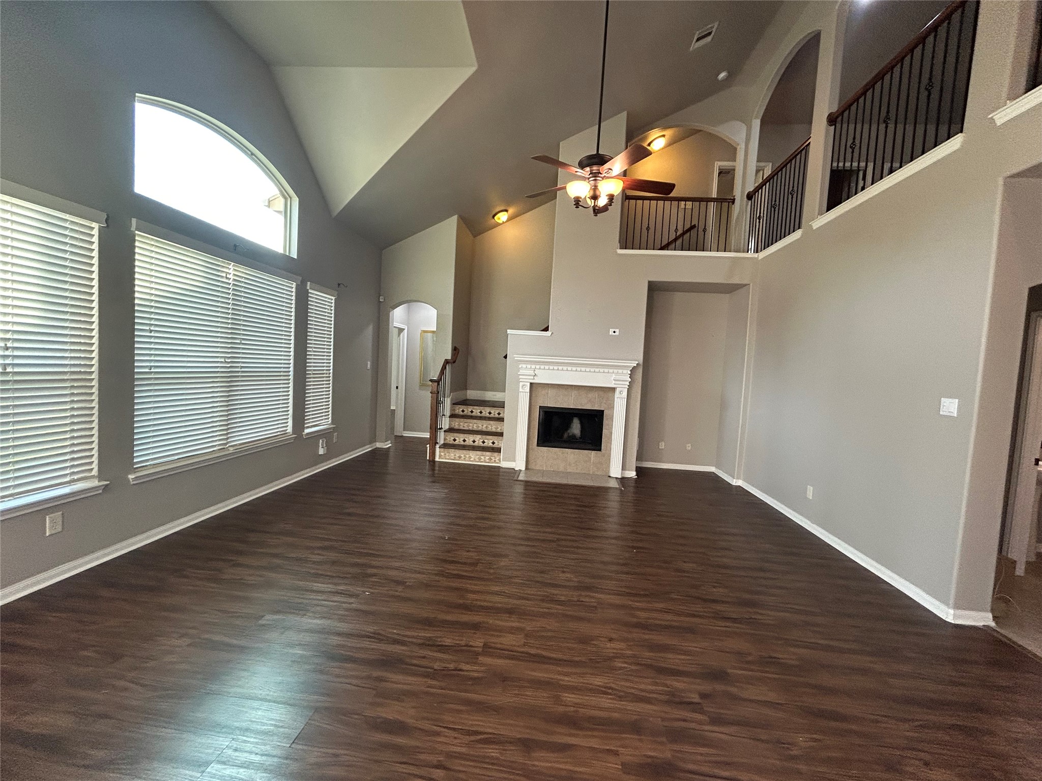 7936 Lake Commons Drive Rosenberg, TX 77469 - Photo 12 of 34 an empty room with wooden floor fireplace and windows