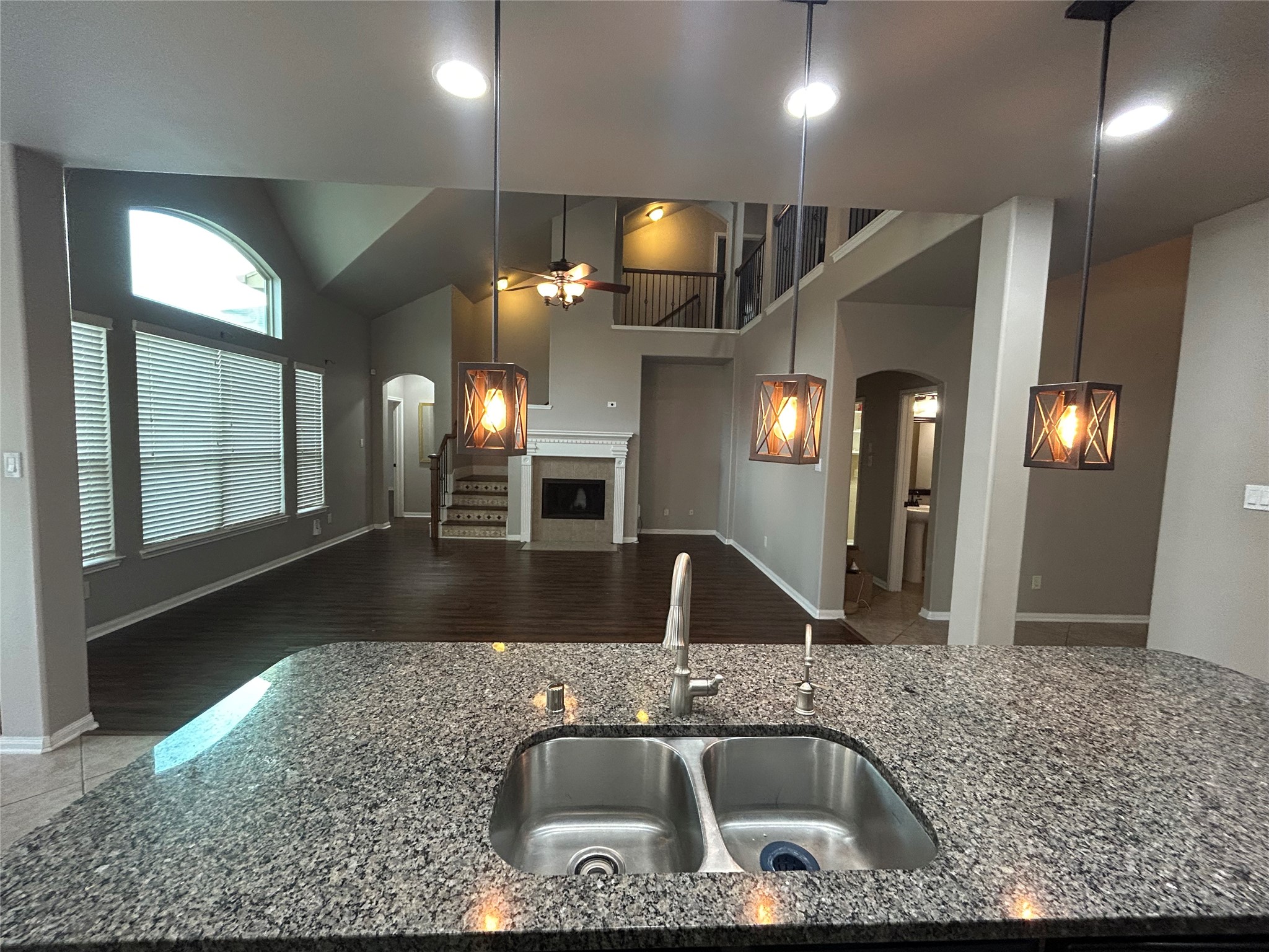 7936 Lake Commons Drive Rosenberg, TX 77469 - Photo 13 of 34 a kitchen with kitchen island a sink and a mirror