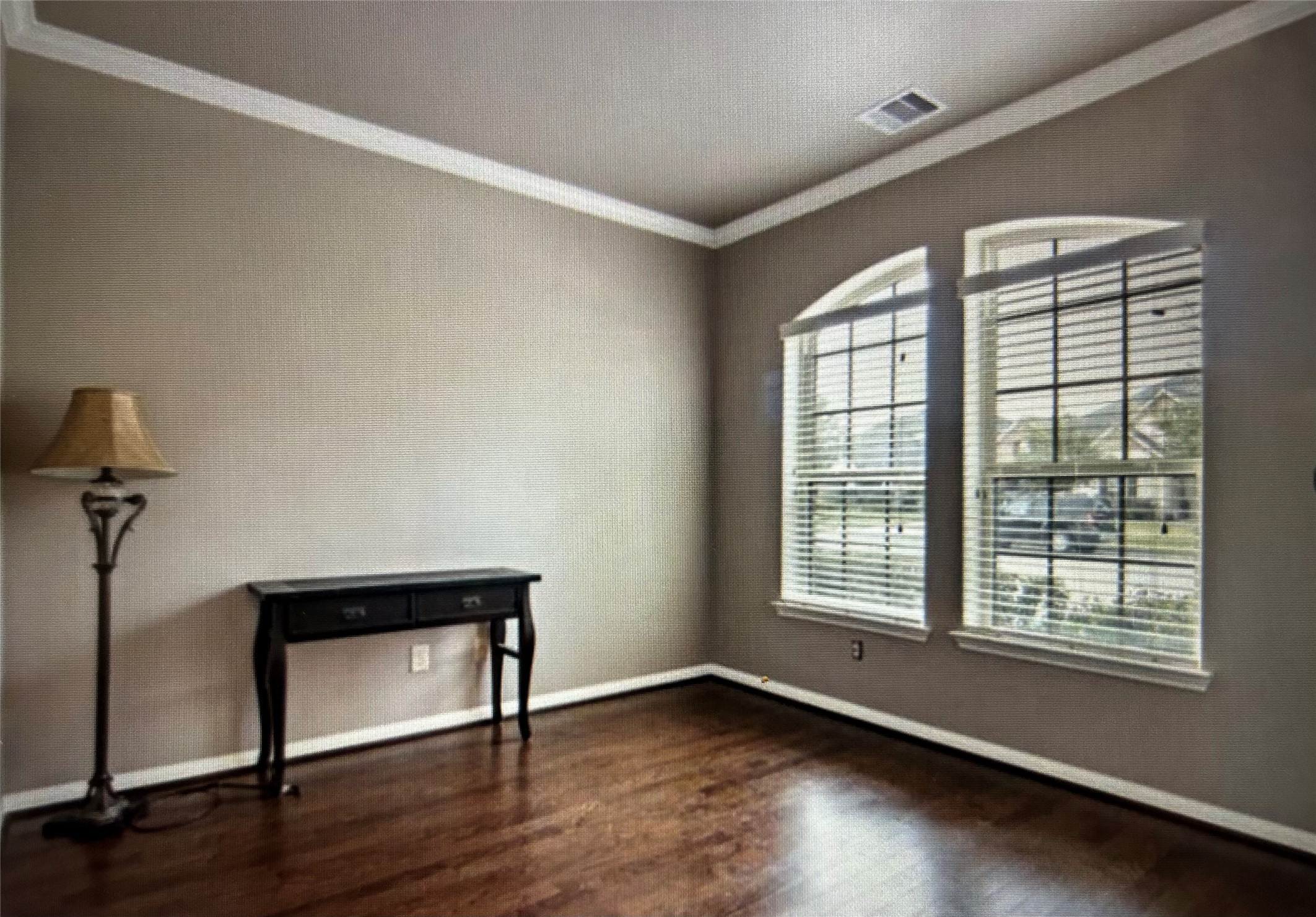 7936 Lake Commons Drive Rosenberg, TX 77469 - Photo 7 of 34 a view of an empty room with a window and wooden floor