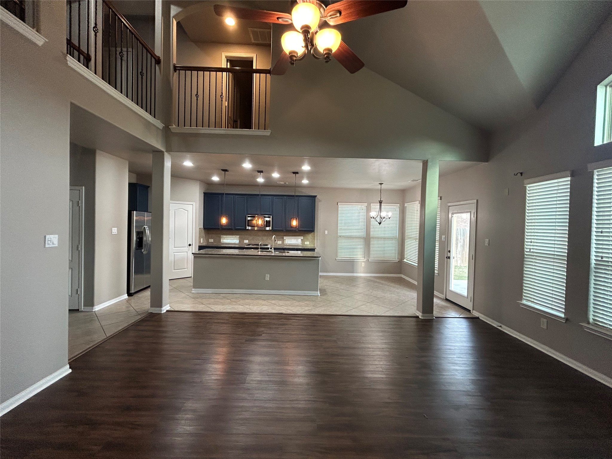 7936 Lake Commons Drive Rosenberg, TX 77469 - Photo 10 of 34 a view of a living room and kitchen with stainless steel appliances kitchen island