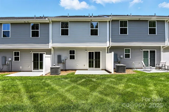 a view of a house with backyard and a chair