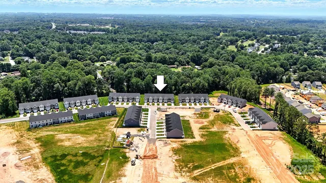 a aerial view of a residential apartment building with a yard