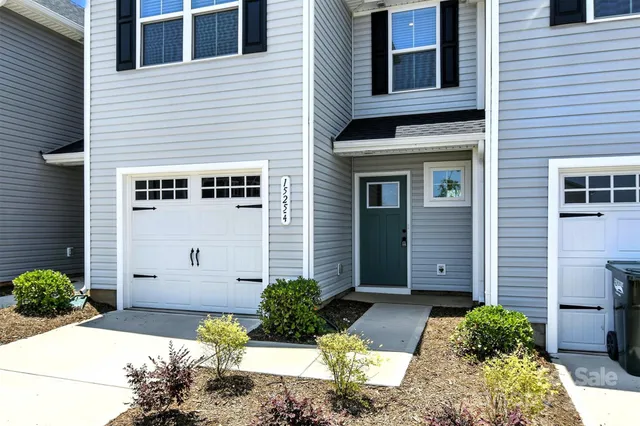 a view of a brick house with many windows