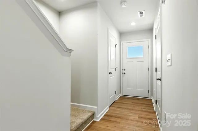 a view of a kitchen with wooden floor and stairs