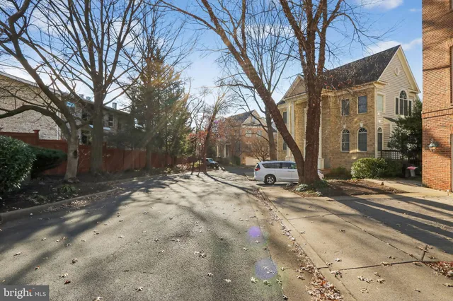 a view of a street with a building and trees