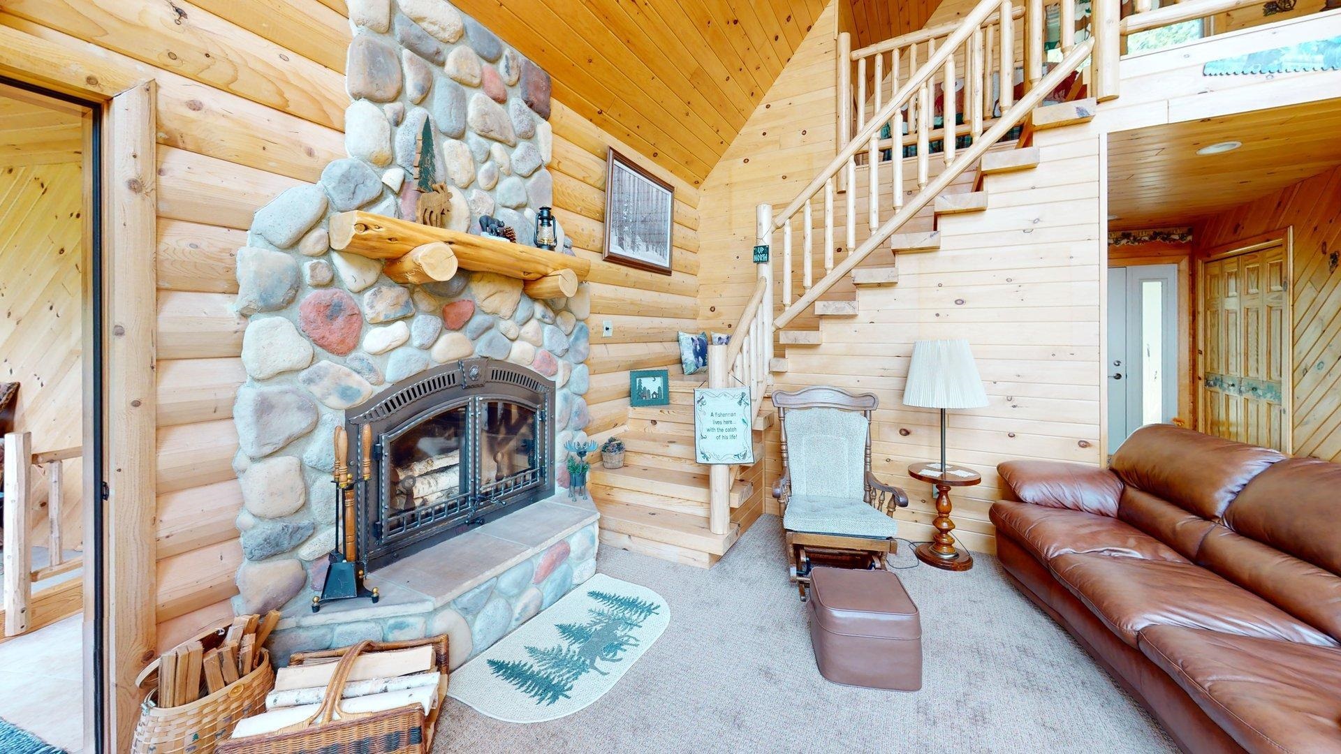 10898 Bessette Road Orr, MN 55771 - Photo 18 of 49 Carpeted living area with wooden ceiling, a fireplace, stairs, and lofted ceiling