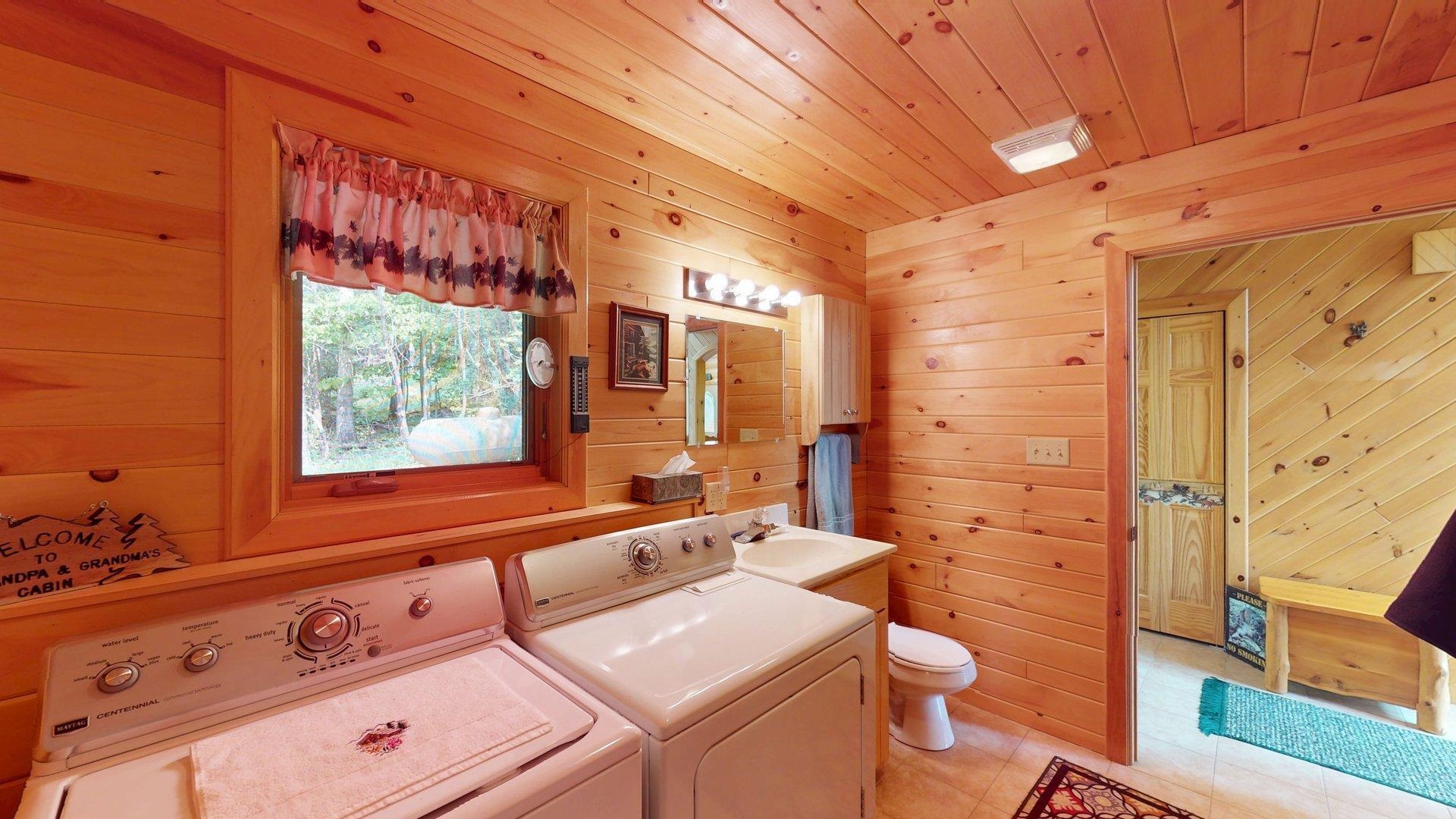 10898 Bessette Road Orr, MN 55771 - Photo 24 of 49 Laundry room with washing machine and clothes dryer, wooden walls, wood ceiling, and light tile patterned flooring