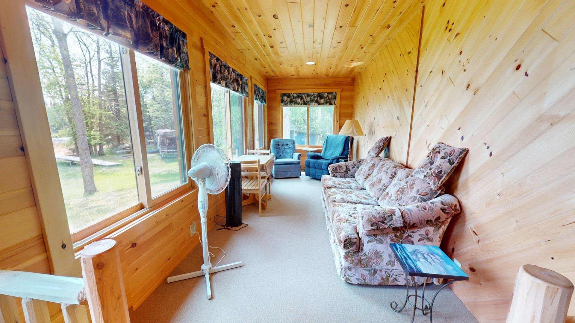 10898 Bessette Road Orr, MN 55771 - Photo 25 of 49 Sunroom / solarium with wood walls, carpet flooring, and wooden ceiling