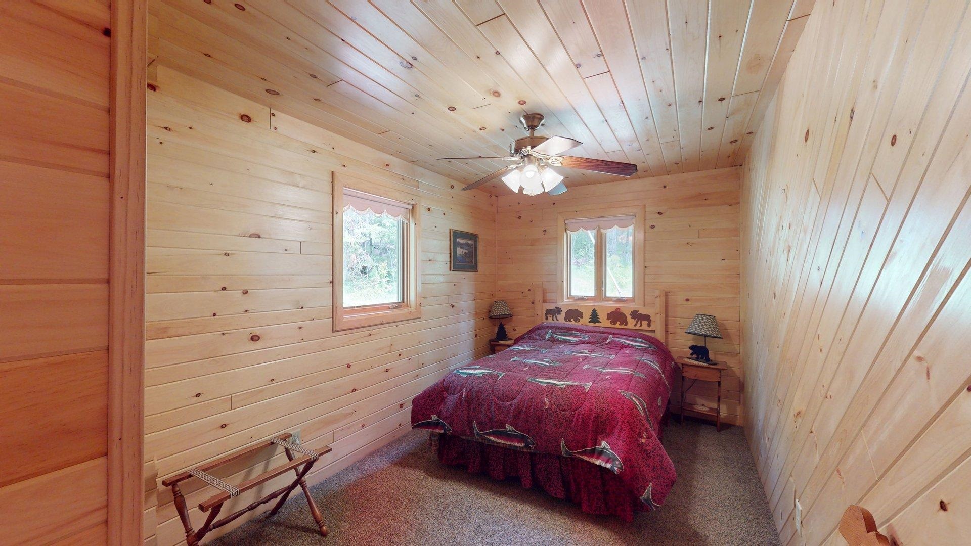 10898 Bessette Road Orr, MN 55771 - Photo 31 of 49 Bedroom with carpet, wood walls, and wooden ceiling