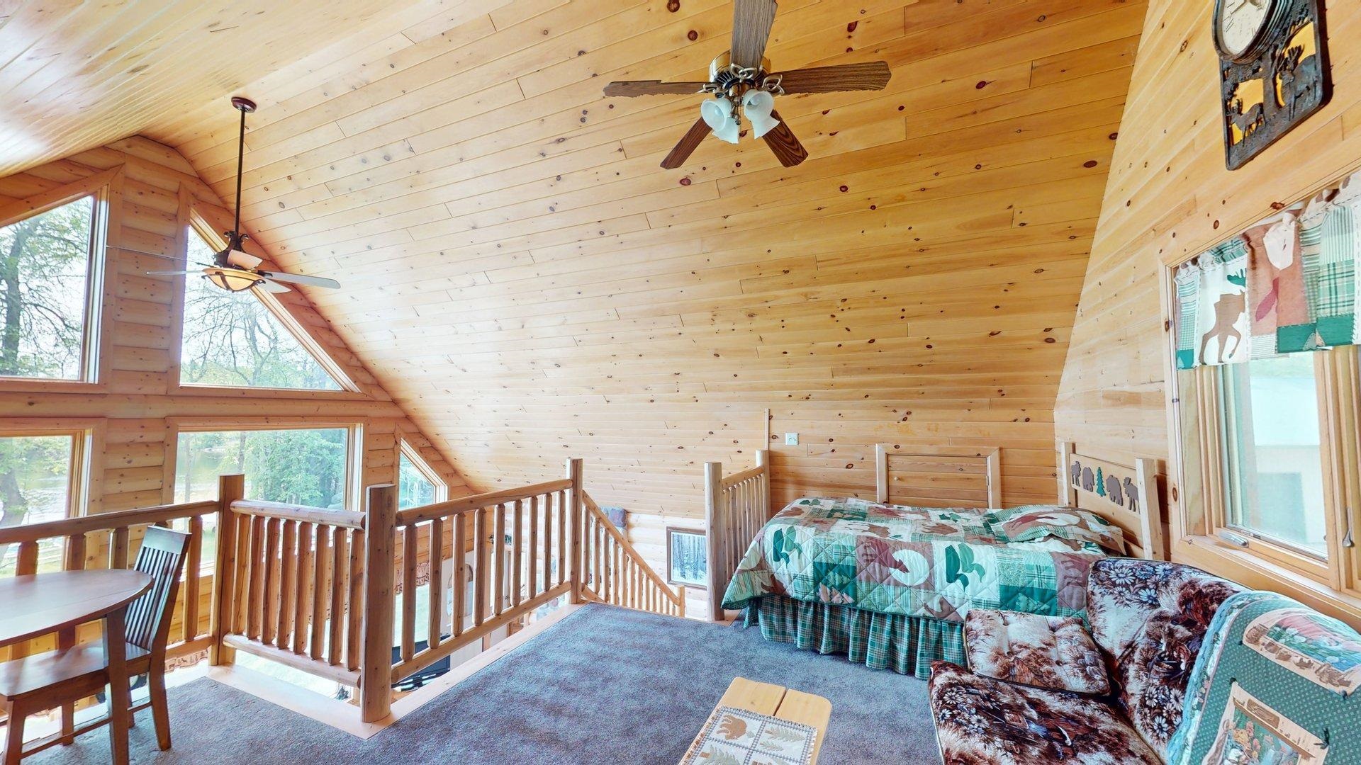 10898 Bessette Road Orr, MN 55771 - Photo 35 of 49 Carpeted bedroom featuring multiple windows, wood ceiling, wooden walls, and high vaulted ceiling