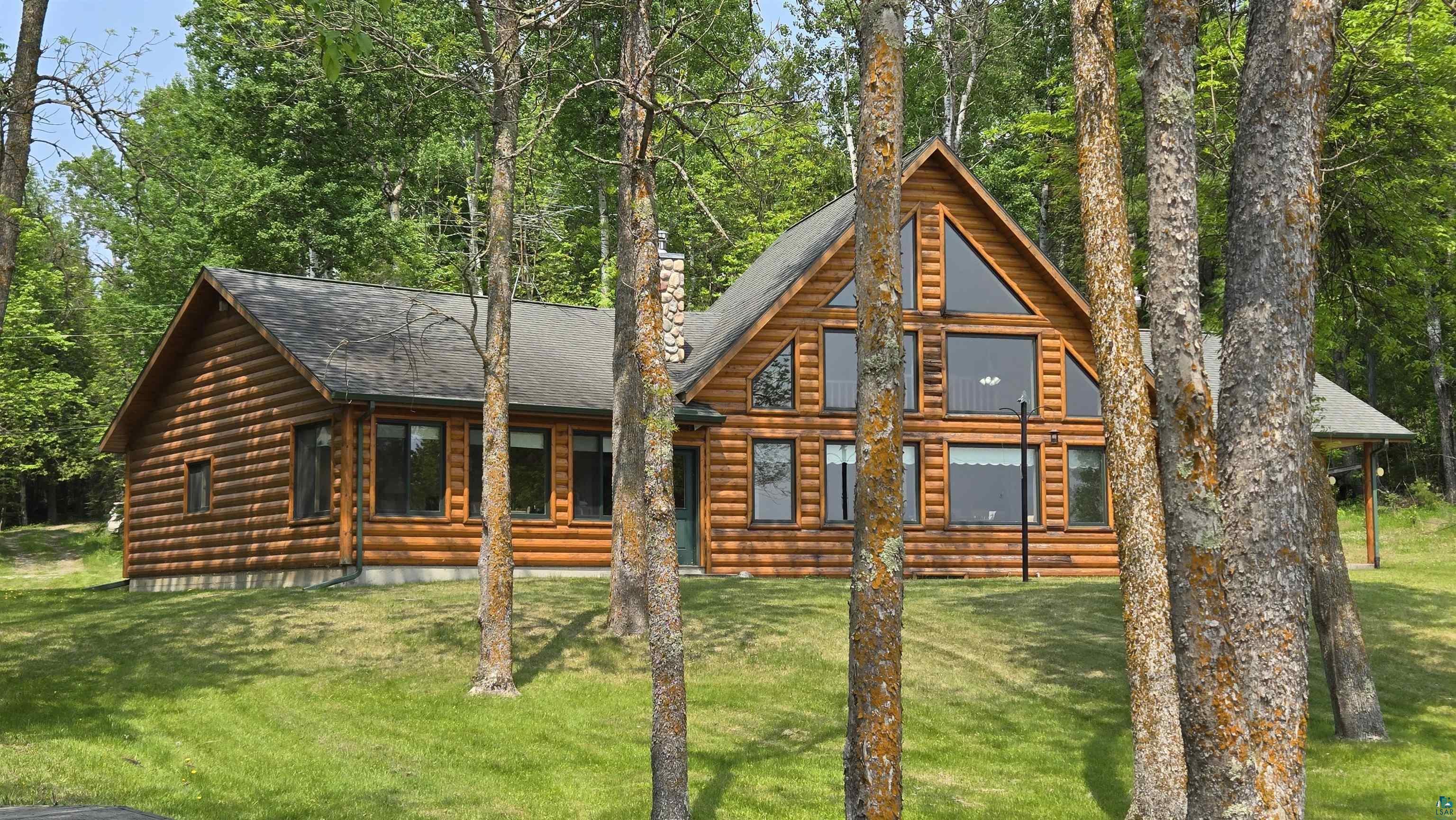 10898 Bessette Road Orr, MN 55771 - Photo 6 of 49 Log home with roof with shingles and a front yard