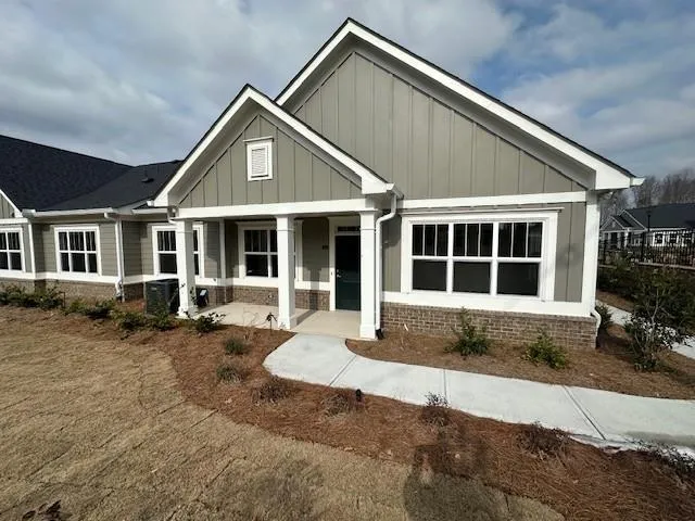 a front view of a house with a yard outdoor seating and garage