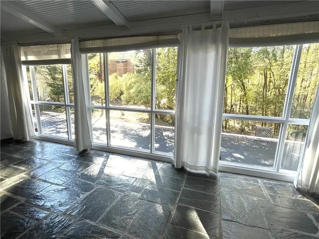 a view of empty room with floor to ceiling window