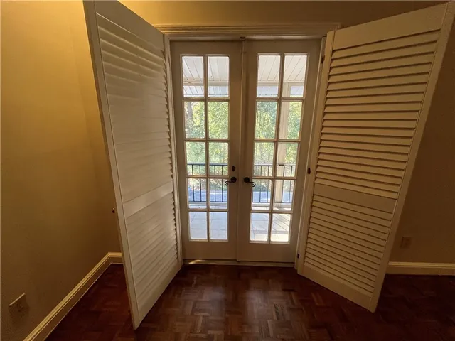 a view of a room with wooden floor and a window