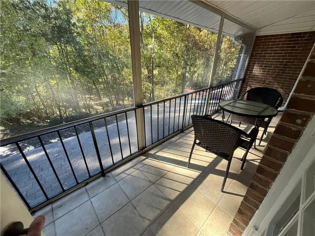 a view of balcony with wooden floor and outdoor seating