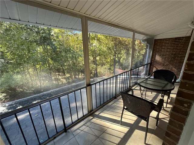 a view of a chairs and table in the balcony