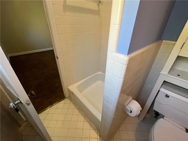 a bathroom with a sink toilet and mirror