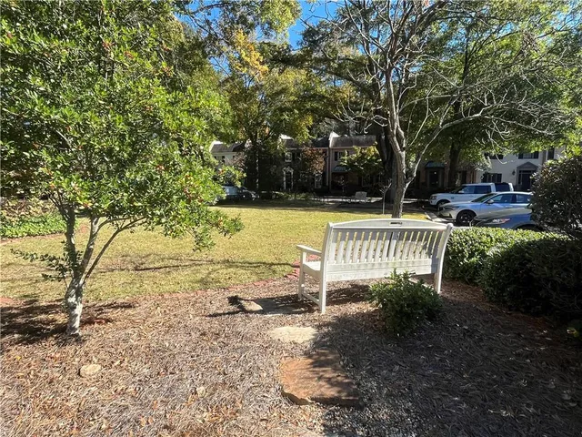 a swimming pool with outdoor seating and yard