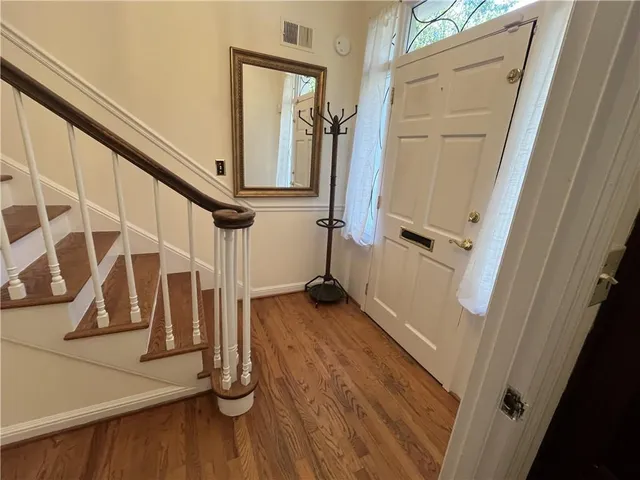 a view of front door and wooden floor