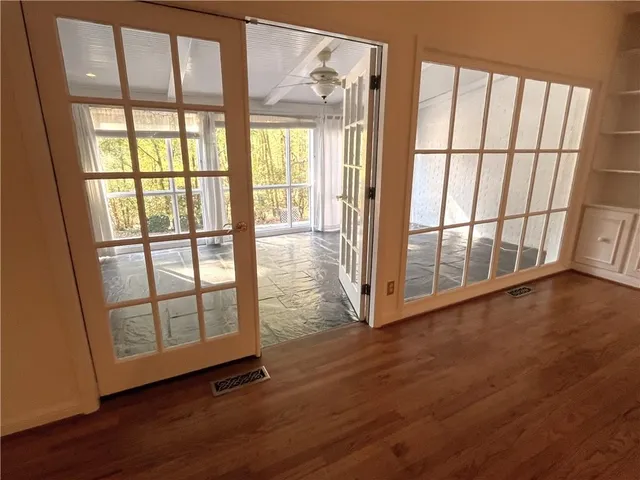wooden floor in an empty room with a window