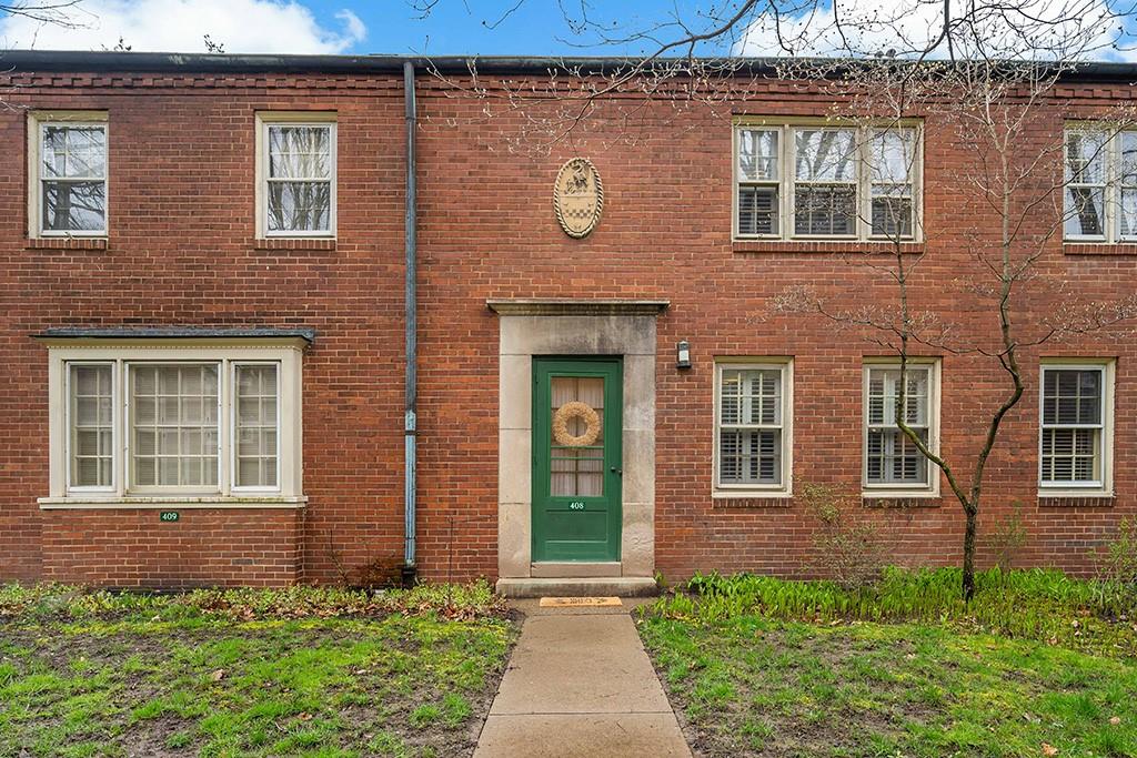 408 Olympia Road Pittsburgh, PA 15211 - Photo 1 of 25 front view of a brick house with a large windows
