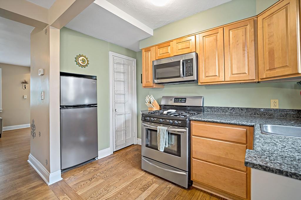 408 Olympia Road Pittsburgh, PA 15211 - Photo 11 of 25 a kitchen with stainless steel appliances granite countertop a refrigerator stove and sink