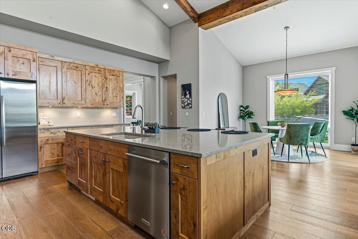 61333 Kindle Rock Loop Bend, OR 97702 - Photo 22 of 53 a kitchen with stainless steel appliances granite countertop a sink a stove and a wooden floors