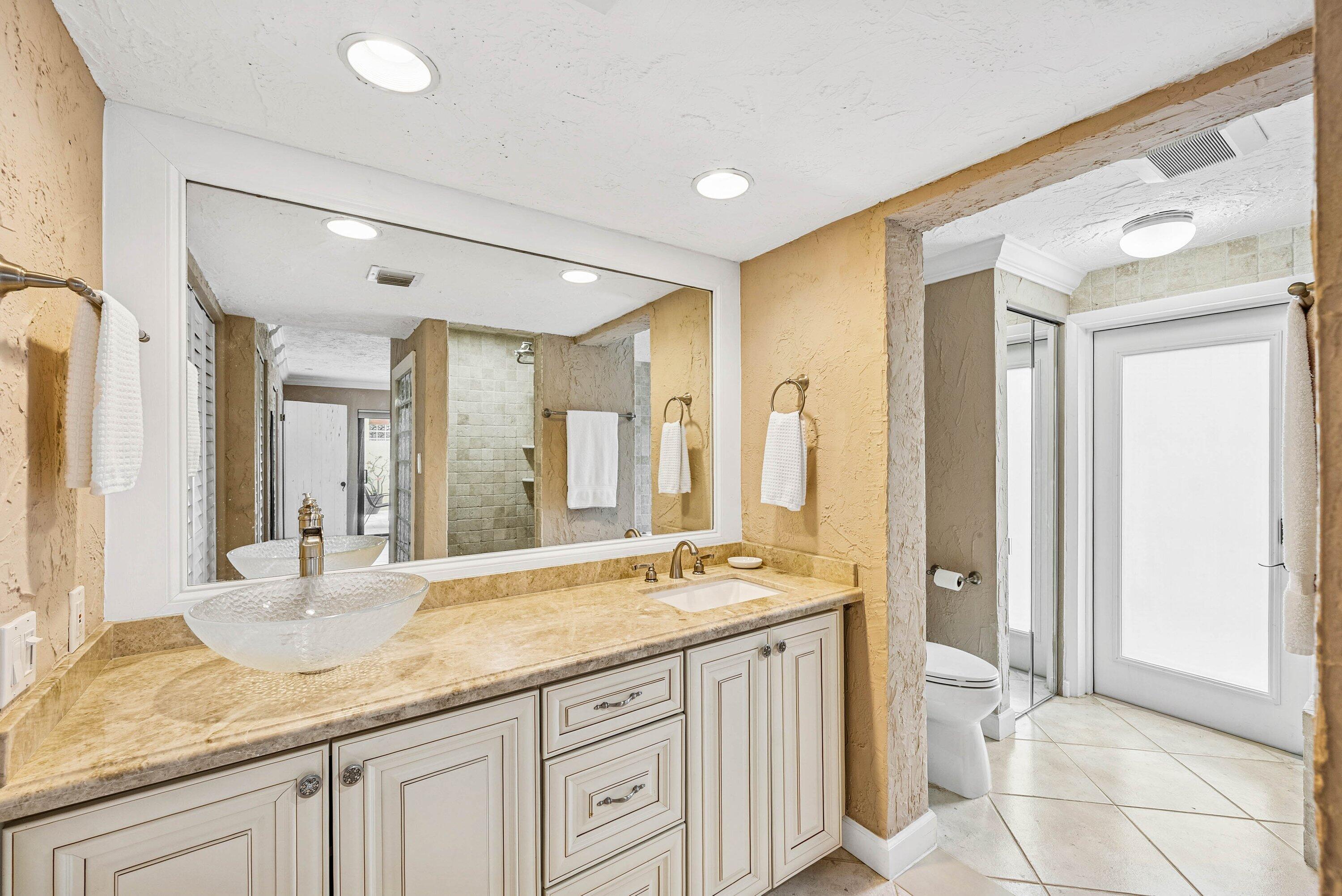 5926 Patio Drive Boca Raton, FL 33433 - Photo 18 of 33 a bathroom with a granite countertop sink and a mirror