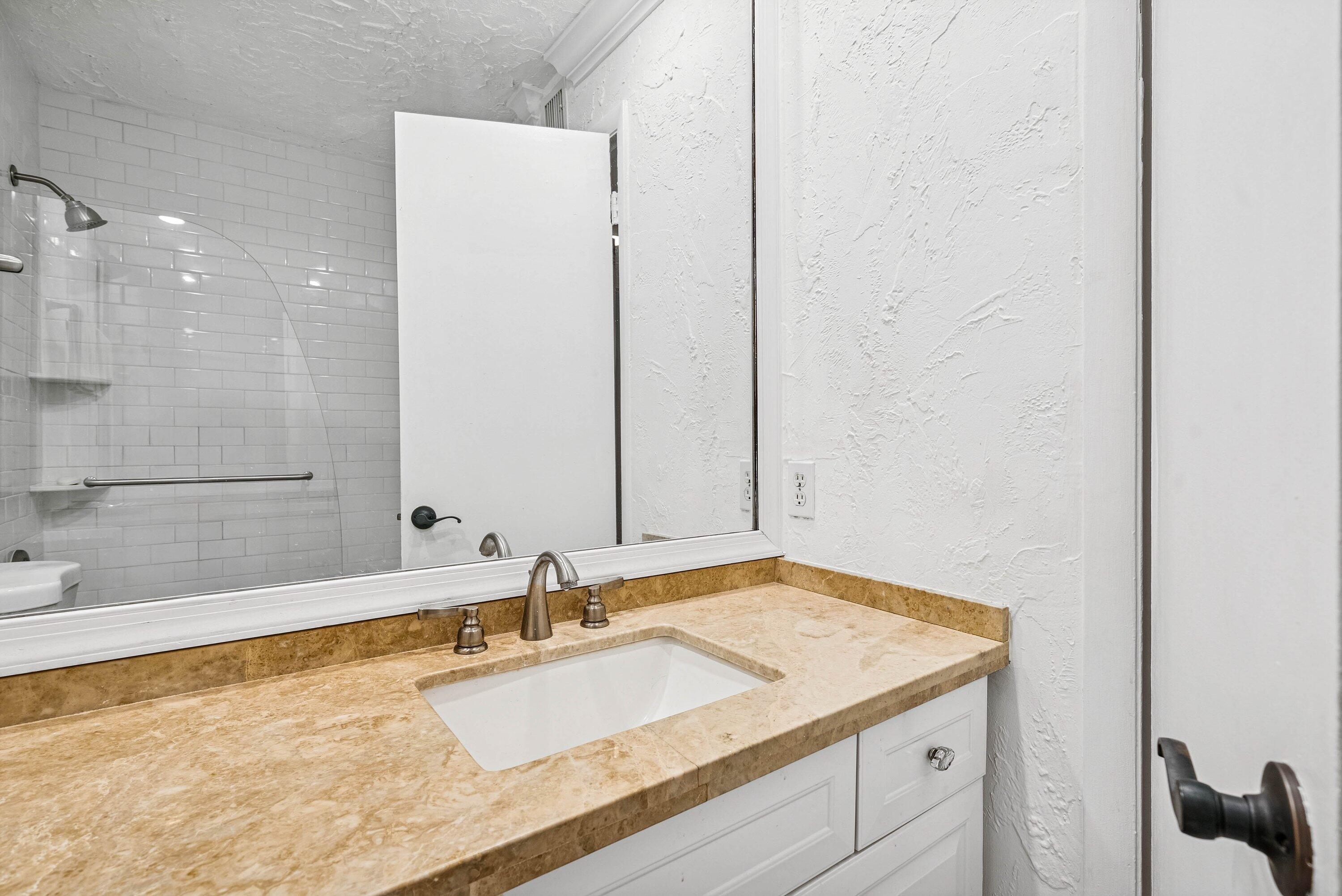 5926 Patio Drive Boca Raton, FL 33433 - Photo 24 of 33 a bathroom with a granite countertop sink and a bathtub