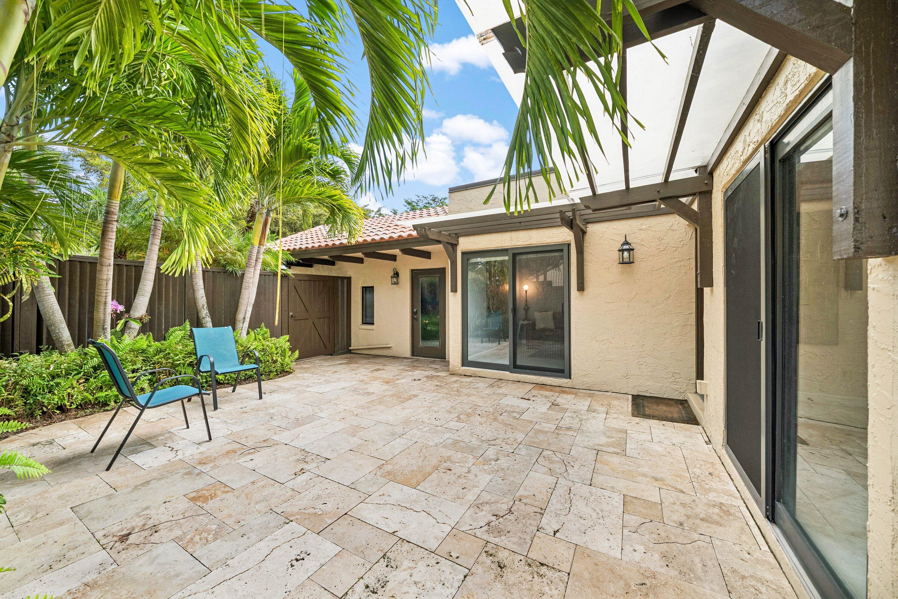 5926 Patio Drive Boca Raton, FL 33433 - Photo 4 of 33 a front view of a house with garden