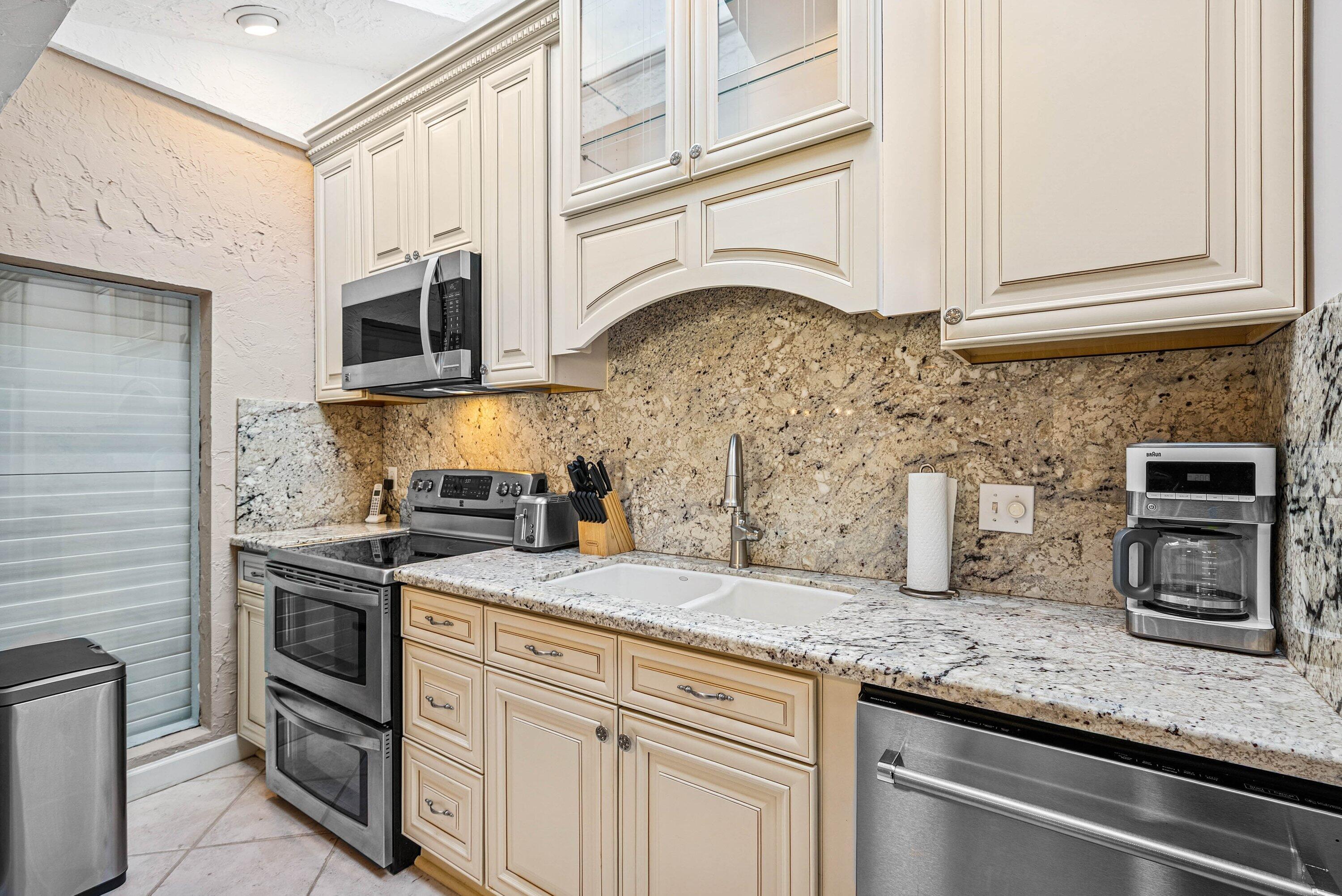 5926 Patio Drive Boca Raton, FL 33433 - Photo 10 of 33 a kitchen with stainless steel appliances granite countertop a sink stove and cabinets