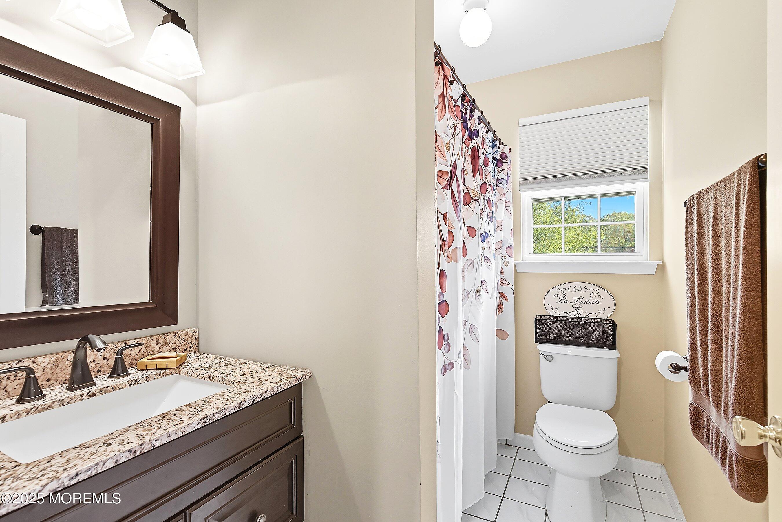 1090 Bennetts Mills Road Jackson, NJ 08527 - Photo 15 of 25 a bathroom with a granite countertop toilet sink and mirror