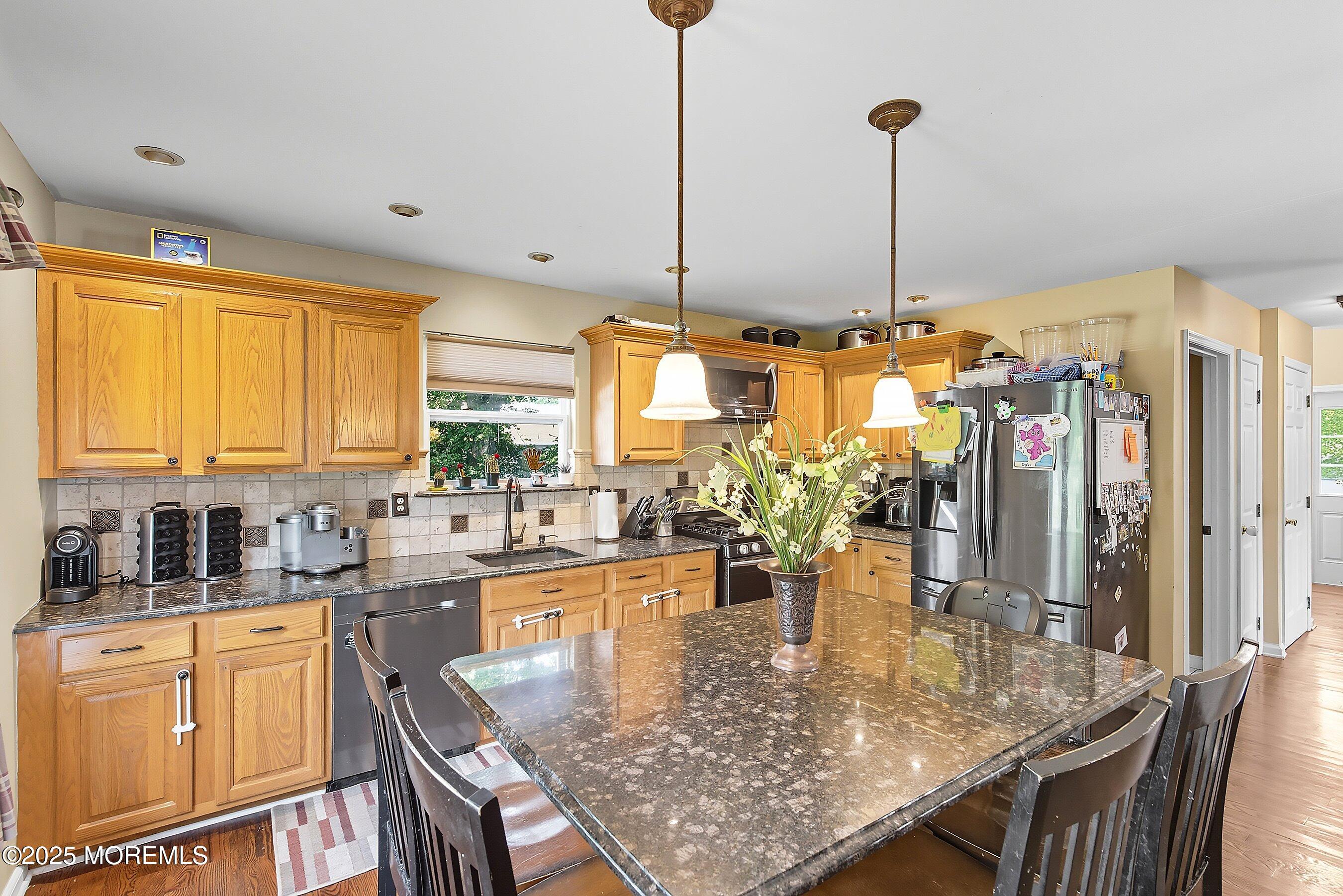 1090 Bennetts Mills Road Jackson, NJ 08527 - Photo 9 of 25 a kitchen with stainless steel appliances granite countertop sink stove and cabinets