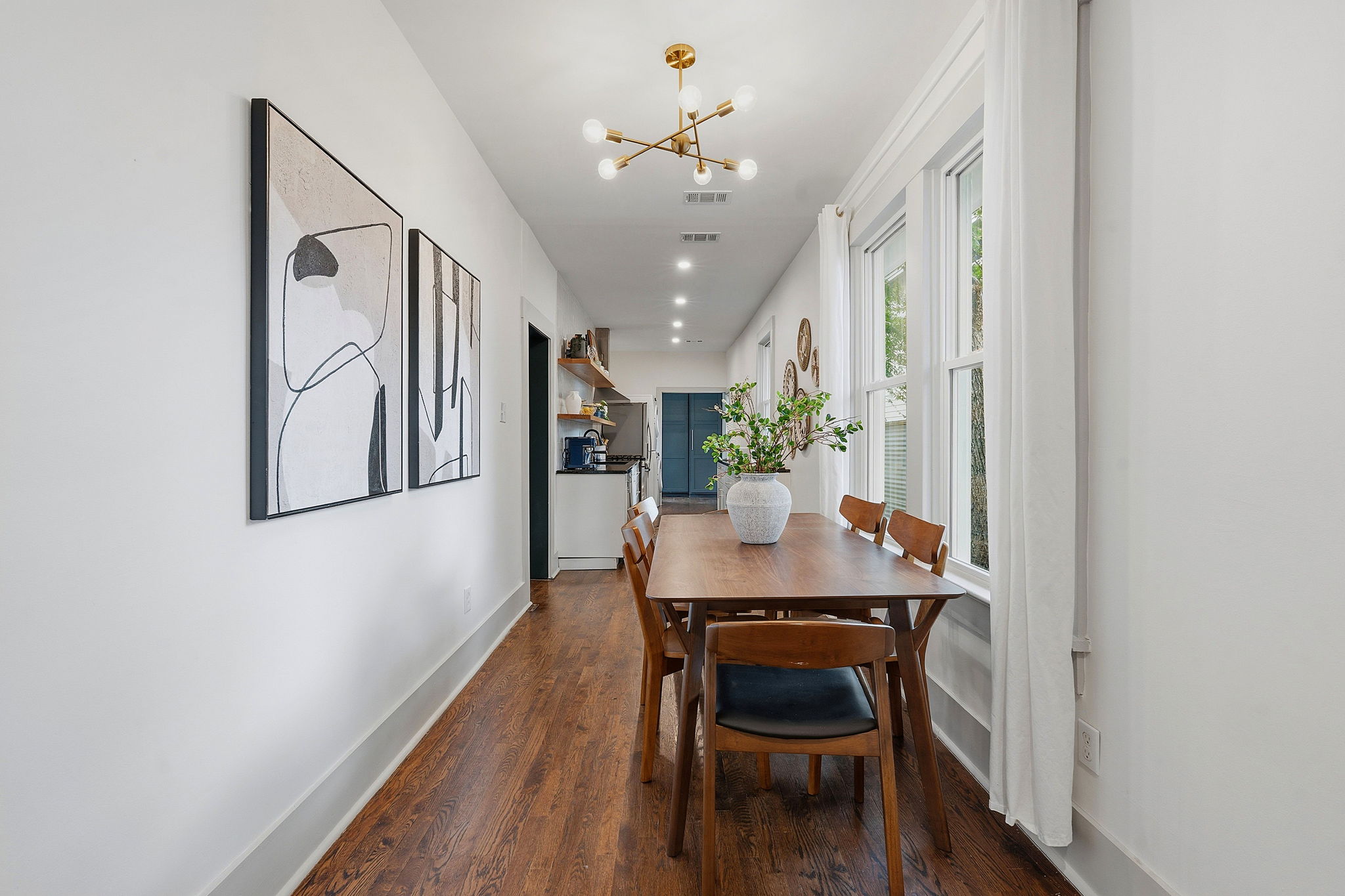 1122 Gunter Street Austin, TX 78702 - Photo 13 of 23 The dining area features hard flooring, light-colored walls, and a modern light fixture