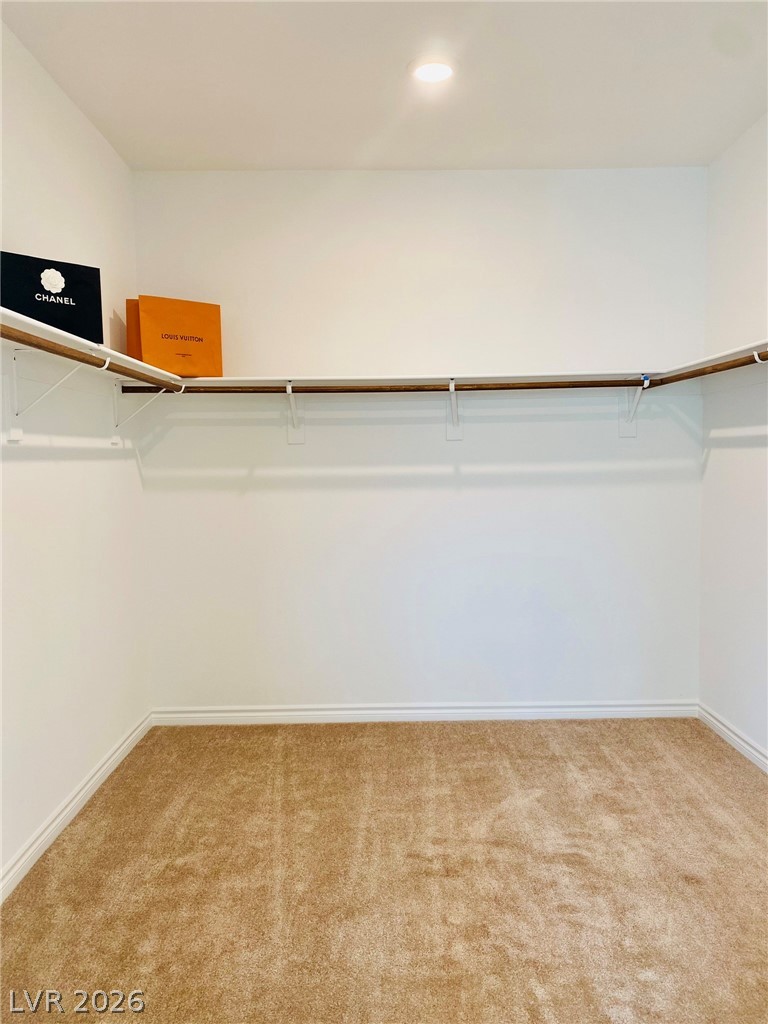 4457 Sawyer Ridge Street Las Vegas, NV 89147 - Photo 25 of 32 This spacious walk-in closet offers ample storage potential for your personal belongings.